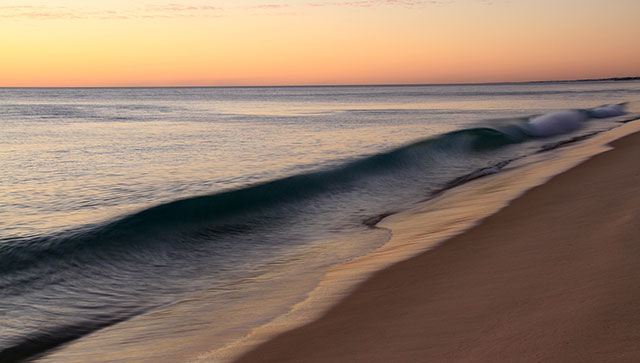 waves on shore at sunrise