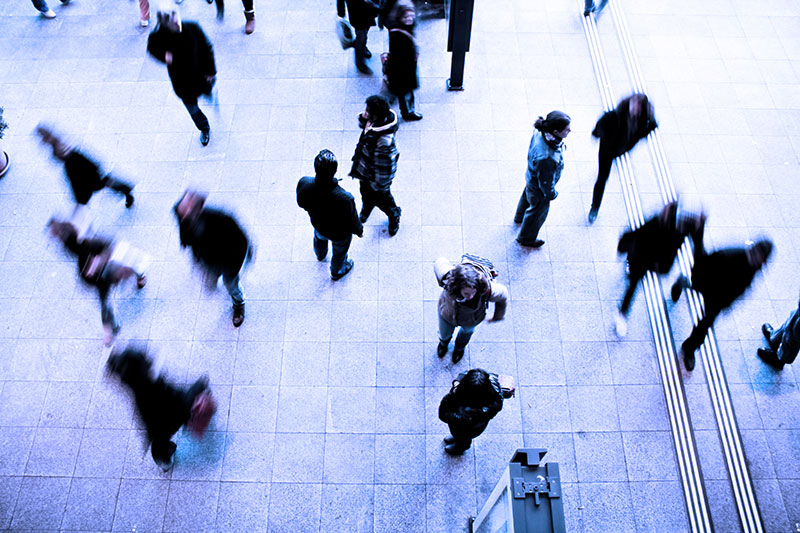 people walking through train station